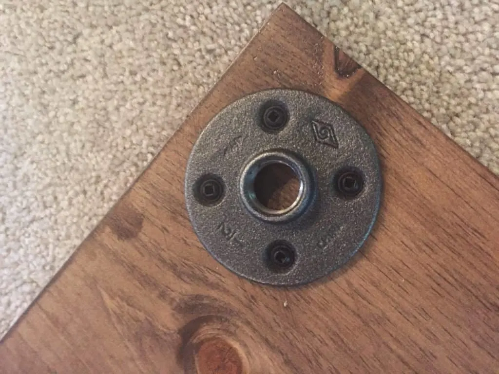 The flange has been screwed into the wood.