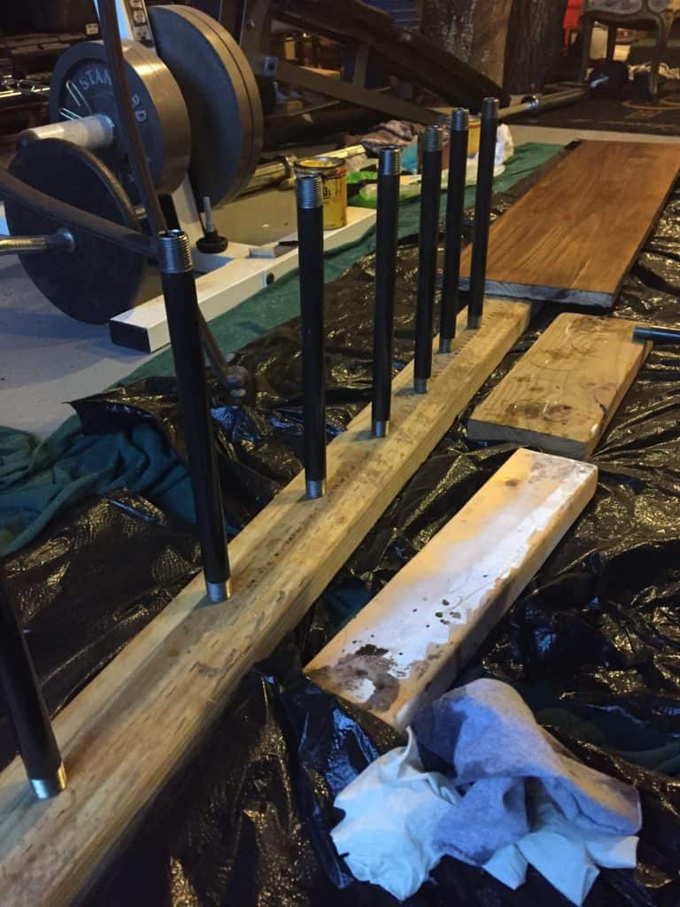 Poly has been applied to the pipes and they are standing upright on a 2x4 drying.