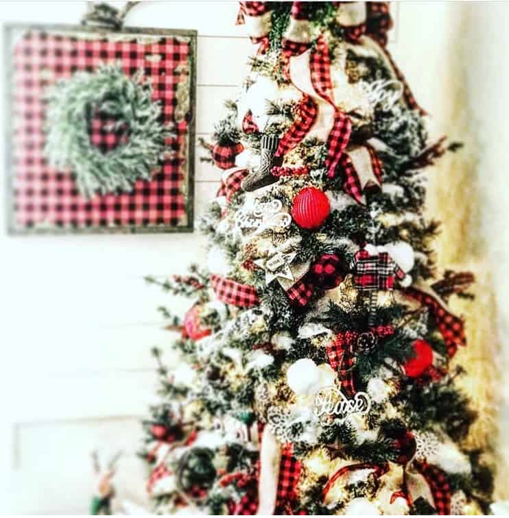 A Christmas Tree with plaid ribbon and red balls.