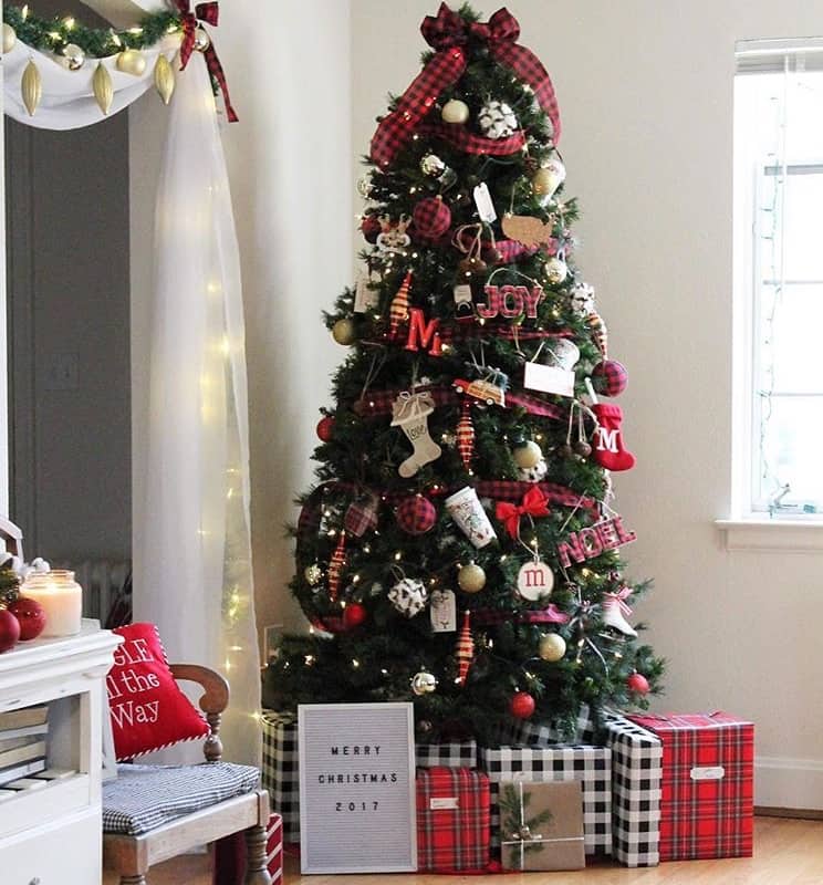 A Christmas tree with packages below in black and white buffalo check and red plaid.