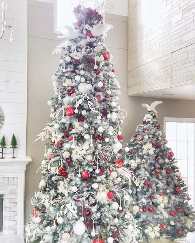 Two flocked Christmas trees with white and red accents.