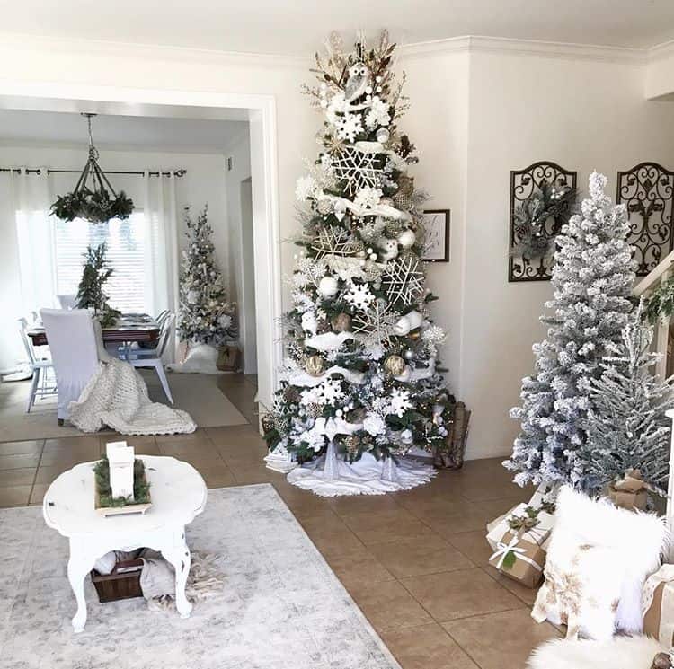 A flocked Christmas tree with large snowflakes and white garland.