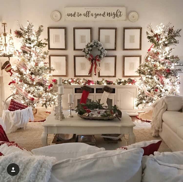 Christmas Trees on either side of a buffet table with framed music prints on the wall above the table.