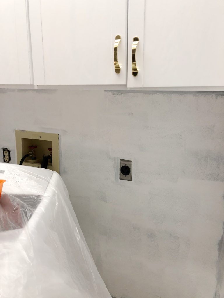 The soon to be farmhouse laundry room got a coat of white paint.