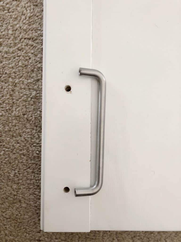 This shows that one of the holes is not in the right place for the new door handles.