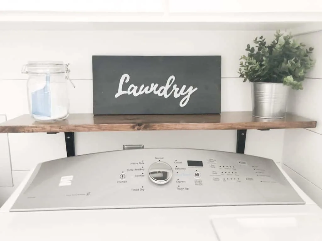 Farmhouse style laundry room sign that is black with the word laundry writen on it.