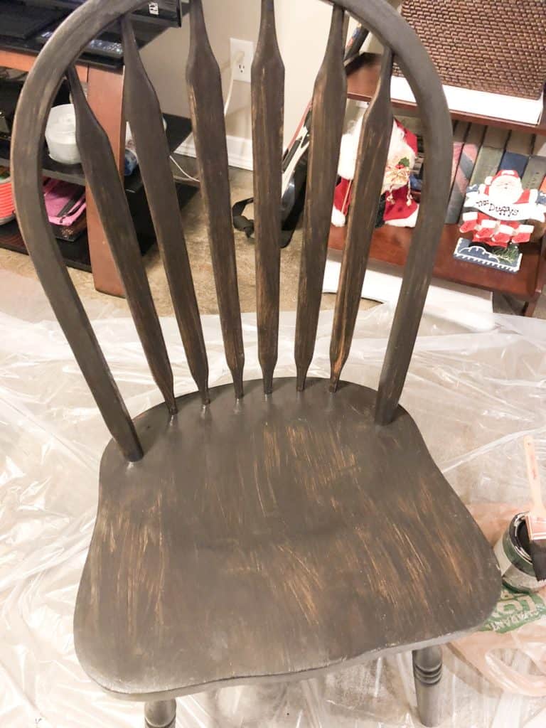 The kitchen chair with one coat of black paint.