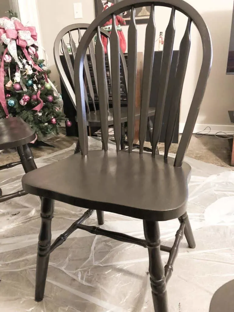 A chair after two coats of black paint.