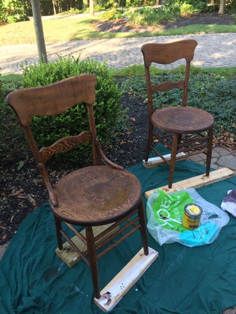 Both chairs after stain sitting on my driveway next to the landscaping.