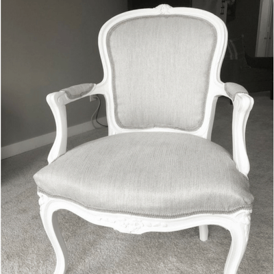 French Chair with gray fabric and white wood.