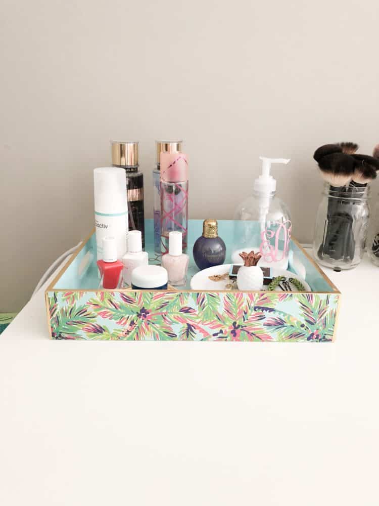 A Lilly Pulitzer tray with makeup organized in it.