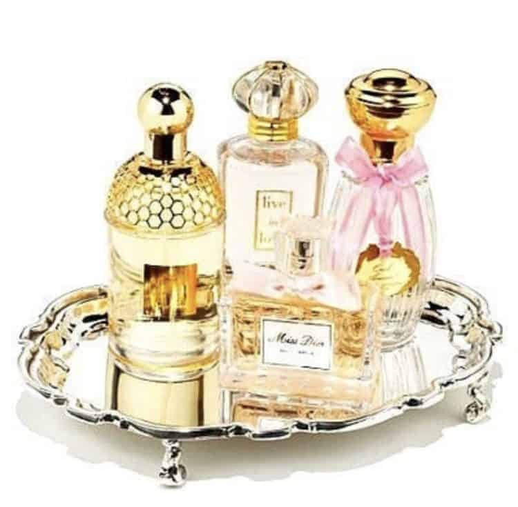 A silver tray with pretty perfume bottles.