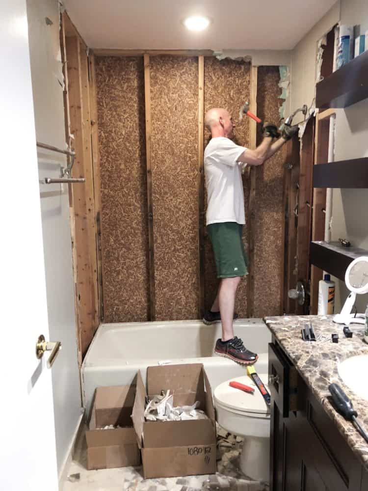 My husband is removing the tile and shower walls and is almost done revealing the studs behind the walls.