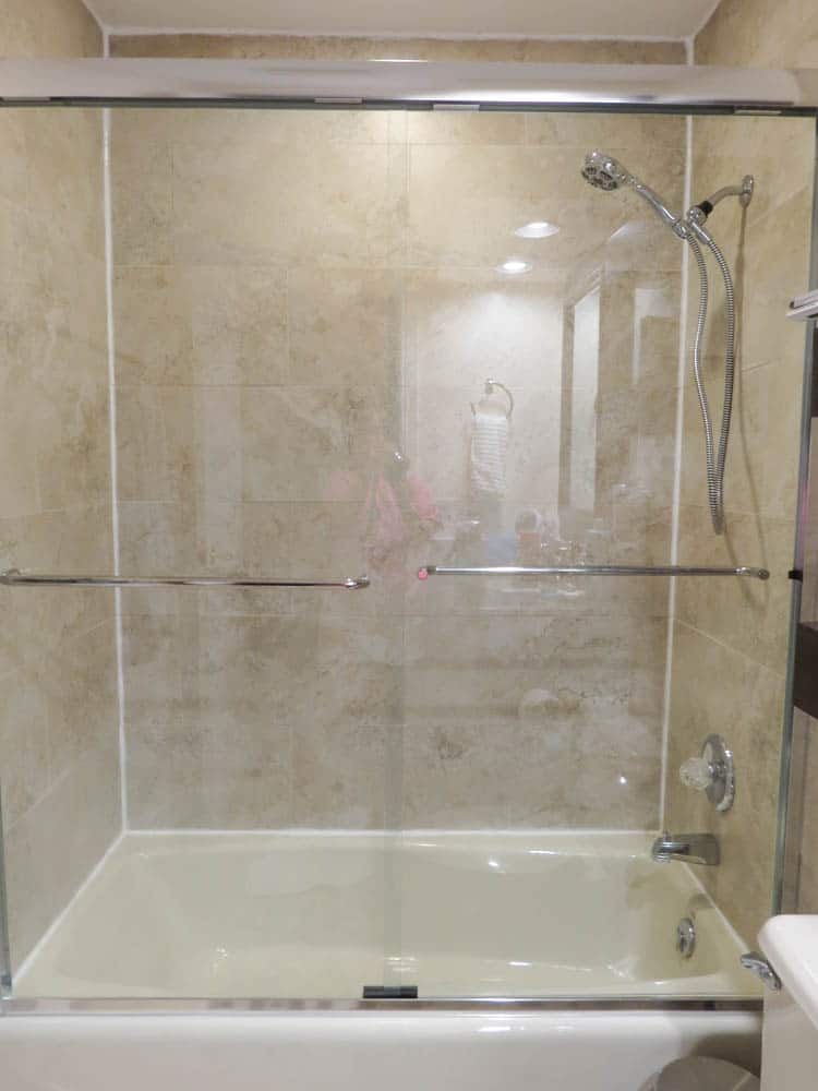 The finished product with he shower head and shower doors installed back on the tub and shower walls.