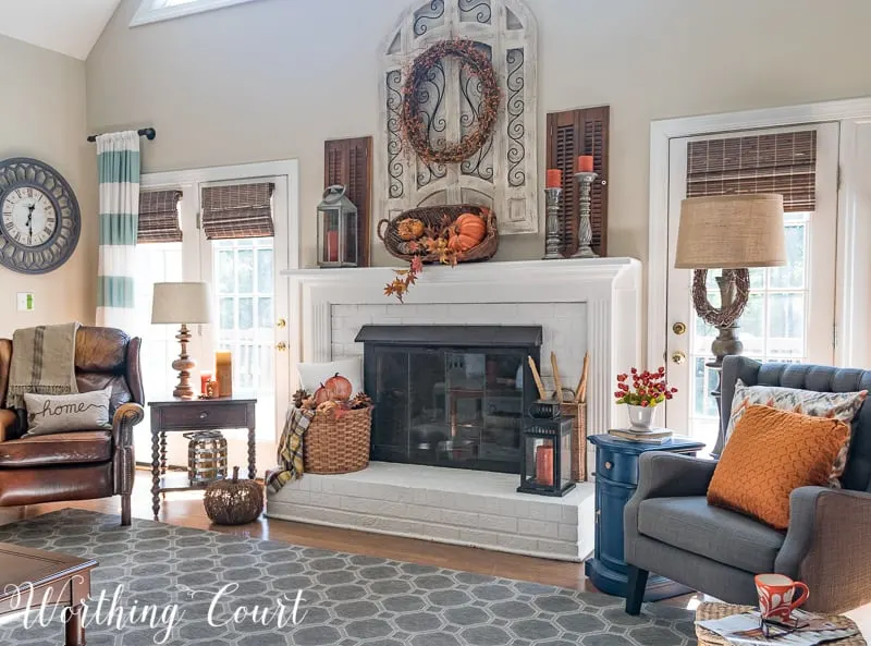 A family room that uses lots of orange fall decor.