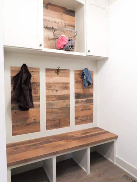 This is a mudroom with a wood accent wall.