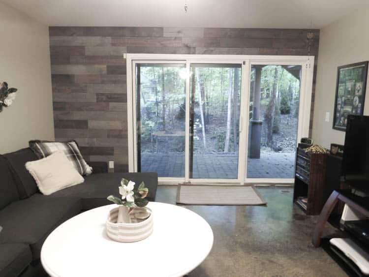 The finished wood wall which makes the trim on the sliding glass door pop with it's white color.