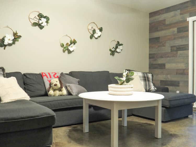 A view of the couch wall with the new hoop wreaths and part of the wood wall.