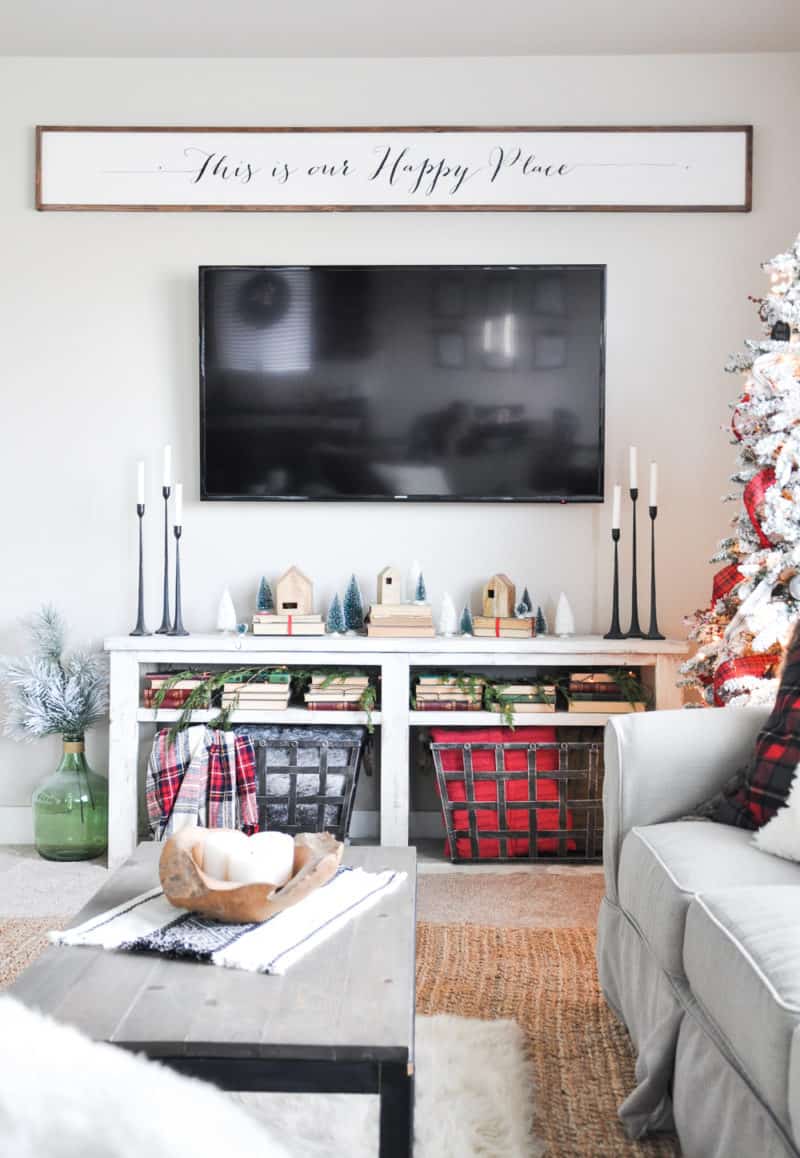 This family room has a console table under the mounted tv that acts as a mantel.