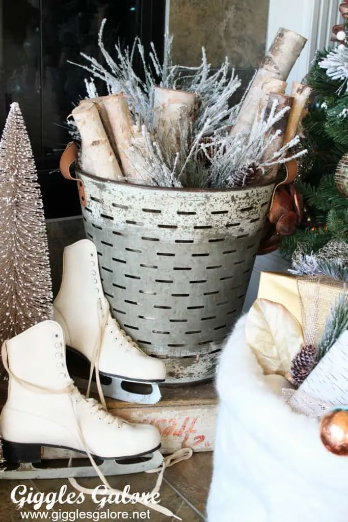 Farmhouse Christmas Decor Olive bucket with branches, skates by a fireplace