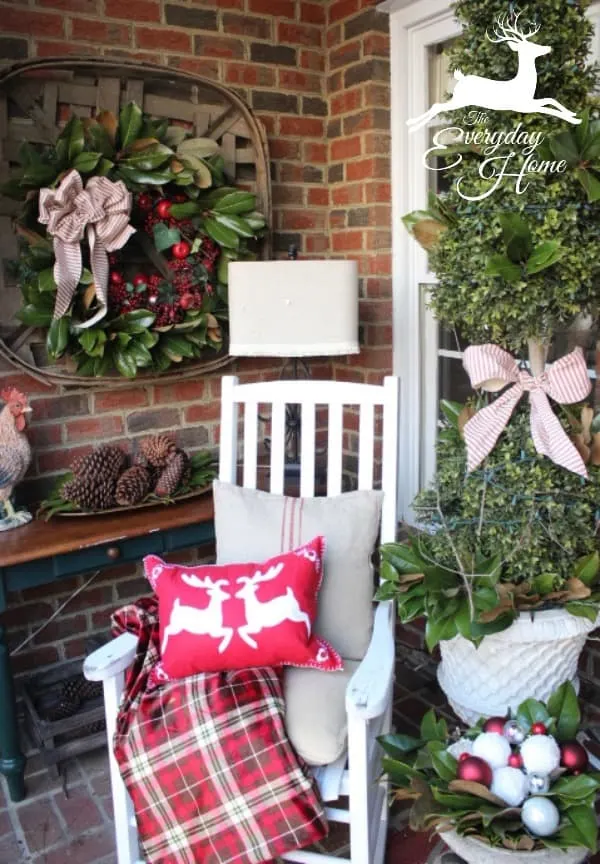 Farmhouse Christmas Decor - a front entry with a christmas tree, rocking chair and lots of red decor