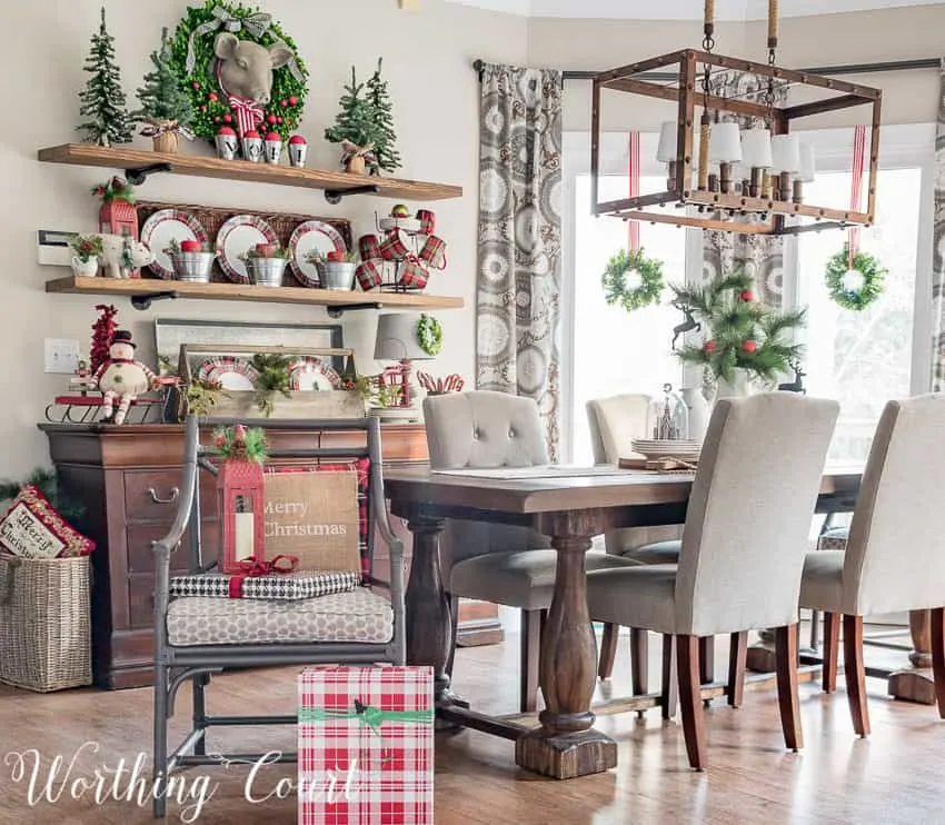 Farmhouse Christmas Decor, a dining room with lots of red and white decor, beautiful plats on display and mugs on a sideboard