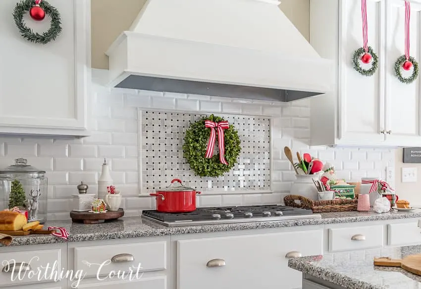 Farmhouse Christmas Decor, a kitchen with lots of red and white ribbon and green wreaths