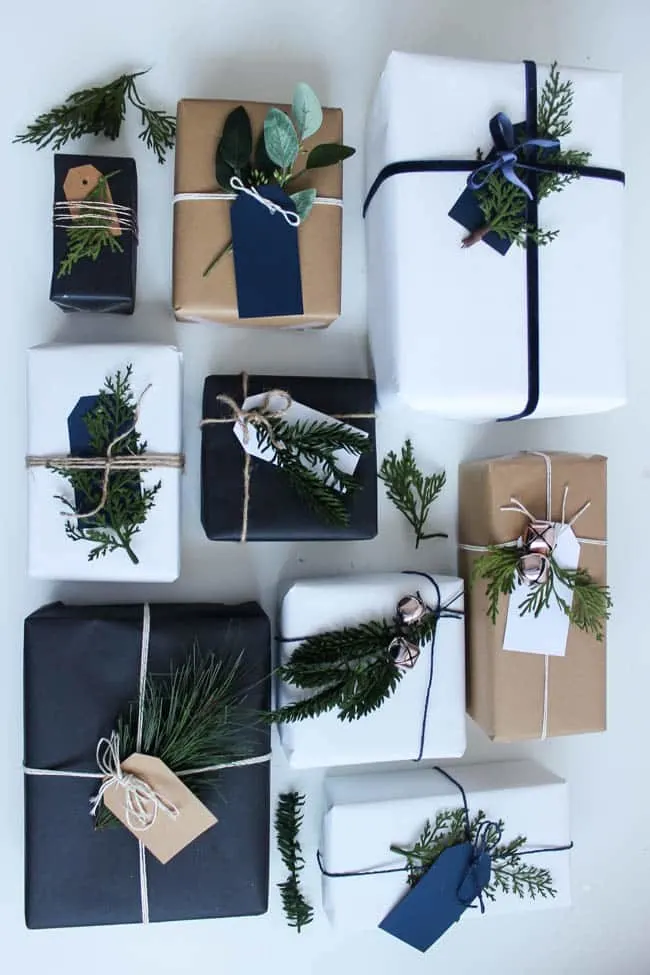 diy gift wrap ideas using solid color paper and sprigs of pine