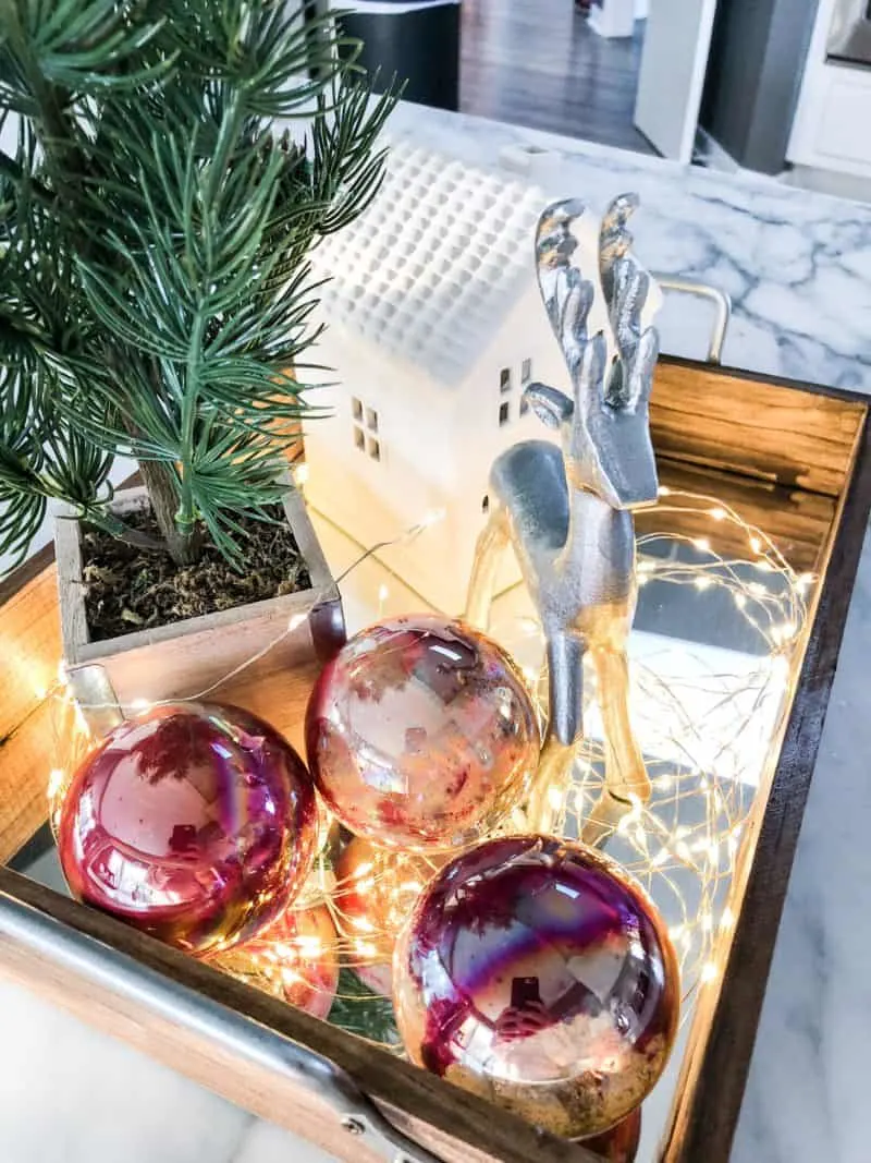 DIY marbled ornaments on a tray with other Christmas decor.