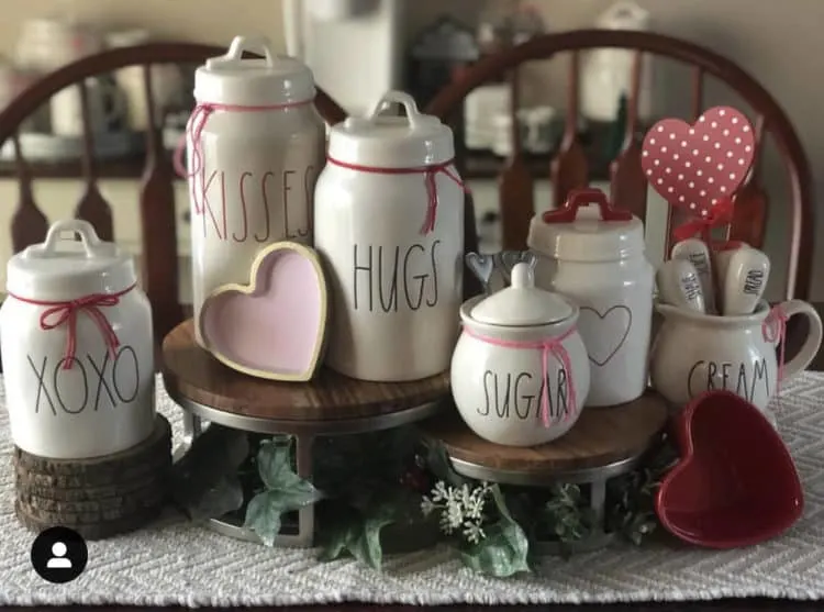 Pretty Rae Dunn canisters with love phrases and pink and red accents.