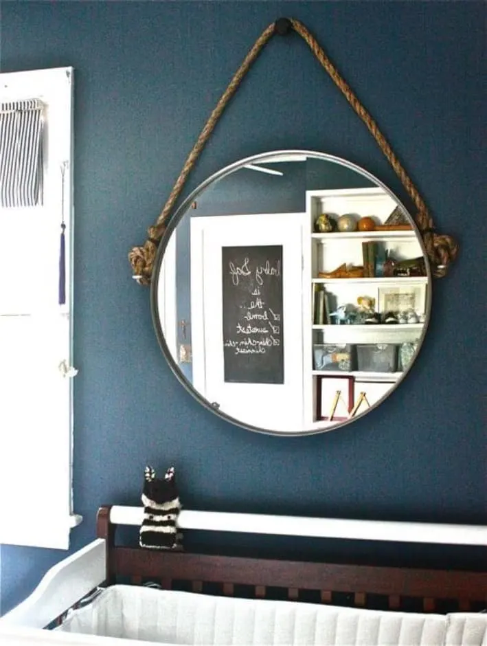 Ikea hack, taking a mirror and adding eye bolts and rope to create a nautical hanging mirror.