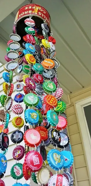 This is a wind chime made with a soup can and hanging bottle caps of various colors.
