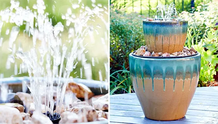 A DIY water fountain using stacked pots and rocks.