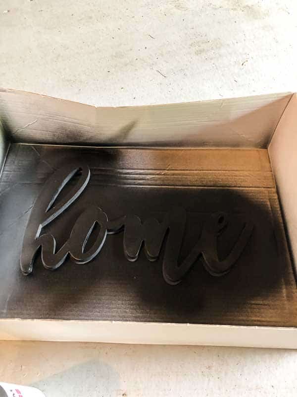 The word home after spray painting it black for my farmhouse sign.