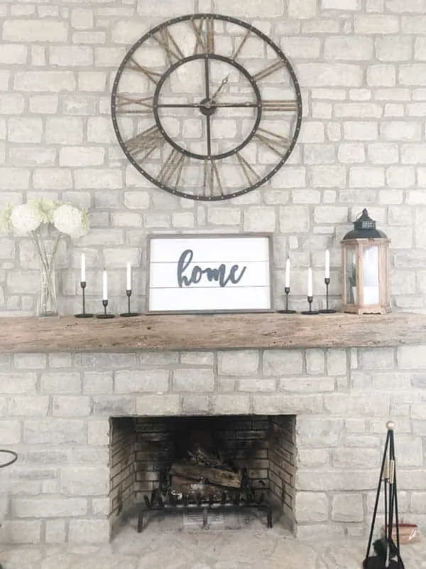 A shiplap sign on my mantel made using shiplap and the word home.