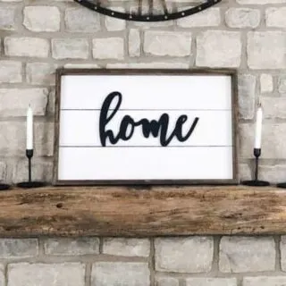 A farmhouse sign on my mantel made using shiplap and the word home on it.