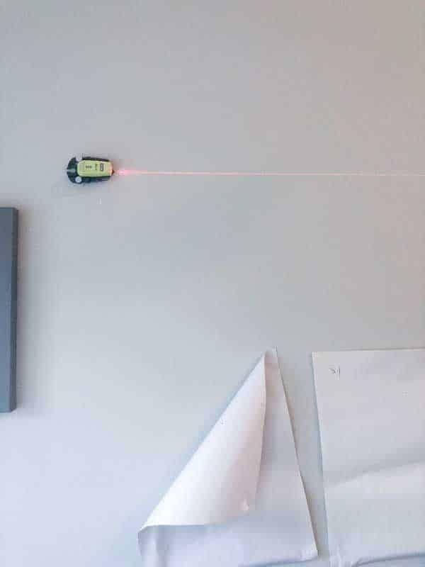 A photo of my laser level shooting a red line across the wall.
