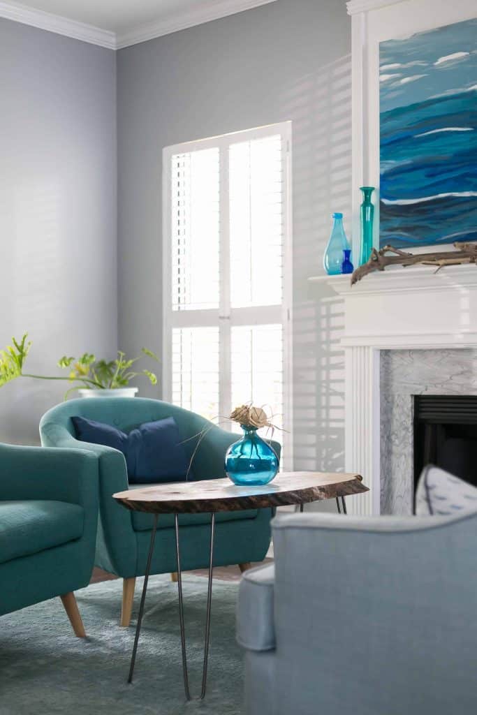 This is the color Online used in a family rom with blue green club chairs and a wood slice coffee table next to a fireplace.