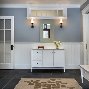 This is Morning Fog used in an entryway with white vertical shiplap wainscotting on the bottom third of the walls with dark gray tile.