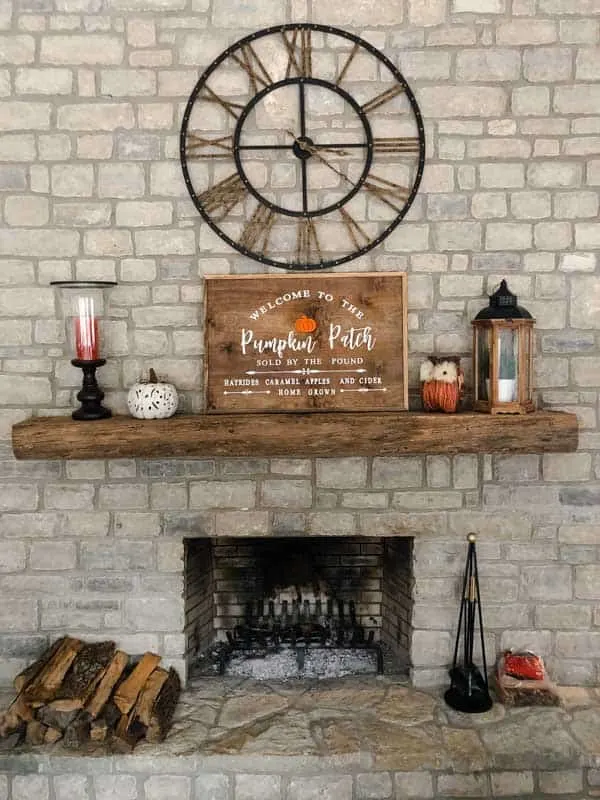 My fall mantle with a fall wood sign that says welcome to the pumpkin patch.