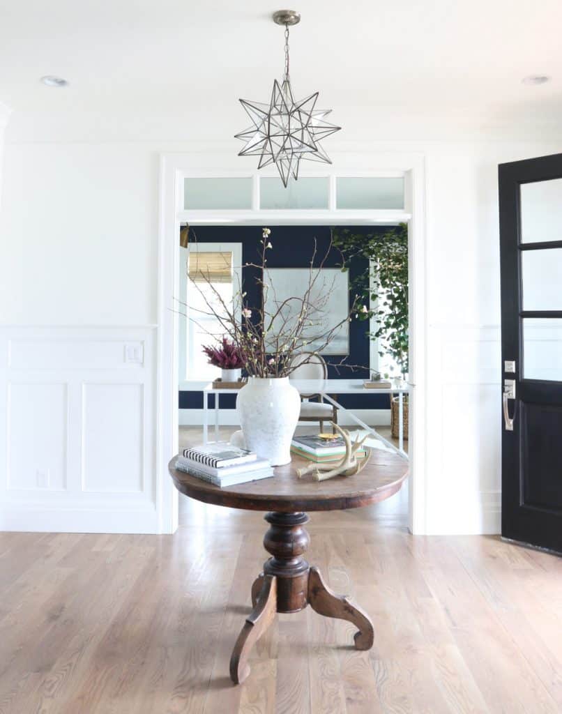 An entryway with white walls and white trim.