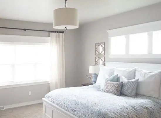 A bedroom painted in Sherwin Williams Agreeable Gray.