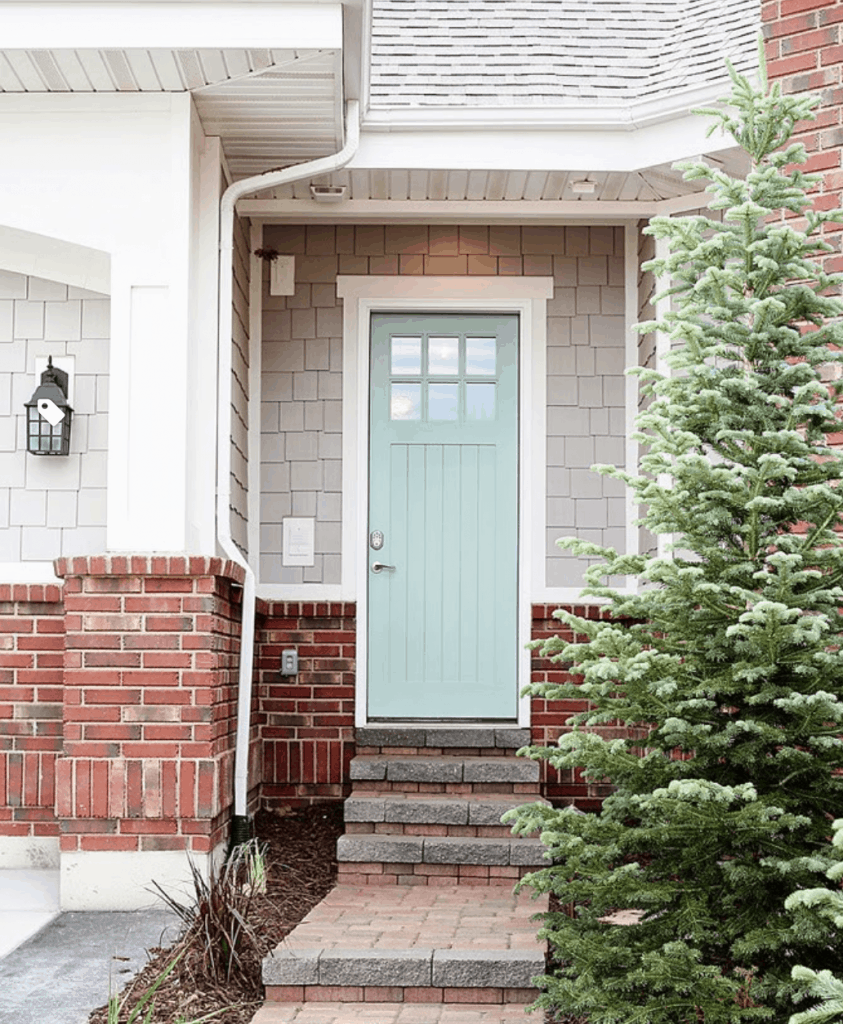 A Gray exterior of a home painted in Sherwin Williams Agreeable Gray.