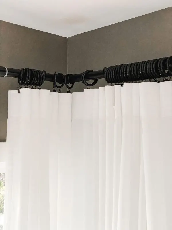 IKEA Ritva Curtains hung on rings with clips highlighting a corner curtain rod.