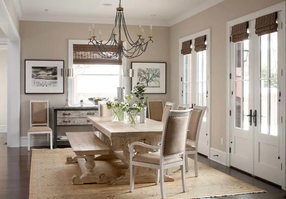 A dining room with a large black and wood chandelier with walls painted in Benjamin Moore Revere Pewter.