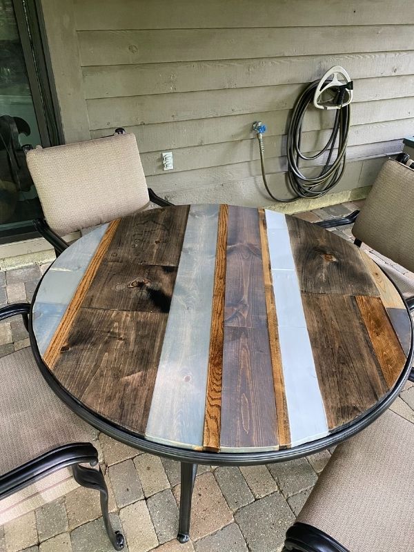 The finished DIY Table Top on the newly spray painted base with the chairs and cushions.