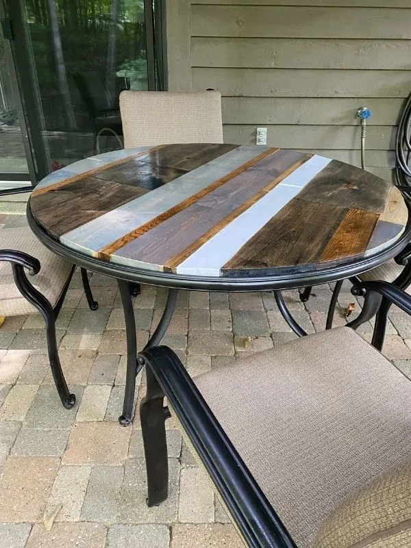 DIY patio table top using scrap wood and stained different colors.