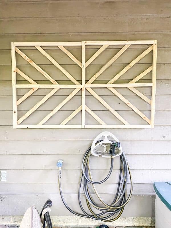 DIY wall art using pressure treated spindles and lathe to create a starburst design.