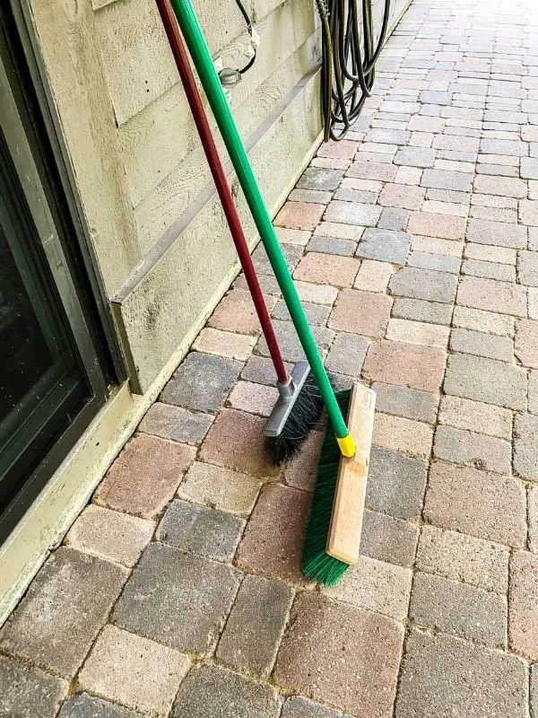 The two brooms that I have used to spread the sand.