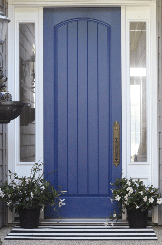 A front door that is a dark blue almost purple in color.